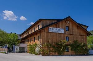 a building with a sign on the side of it at Aktivhotel Wildschütz in Altmünster