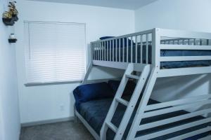 a white bunk bed with a ladder in a room at House in Las Vegas in Las Vegas