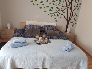 a bedroom with a bed with a tray of food on it at Mediterranean ocean view 4star appartment in Villa in Rijeka