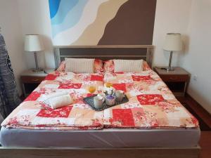 a bed with a red and white quilt on it at Mediterranean ocean view 4star appartment in Villa in Rijeka