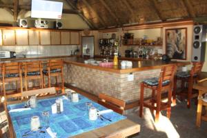 a bar in a restaurant with tables and chairs at Uitkyk Guest Farm in Usakos