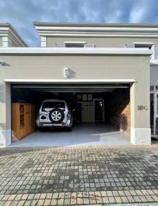 a car is parked inside of a garage at Elgin Townhouse-Excellent location in Cape Town