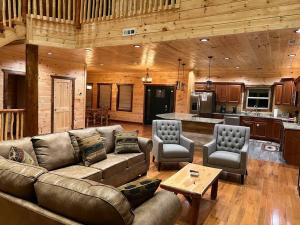 a living room with a couch and chairs and a kitchen at * * 4 Master Bedrooms, Views, Theater, Arcade, EVC in Gatlinburg