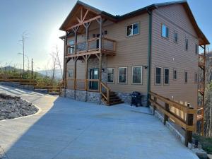 a large house with a balcony on the side of it at * * 4 Master Bedrooms, Views, Theater, Arcade, EVC in Gatlinburg