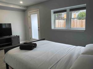 a bedroom with a large bed and a television at Sweet Home - 20 minutes to NYC in Jersey City