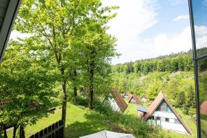 a view from a window of a house with trees at Ferienhaus Waldperle in Ronshausen