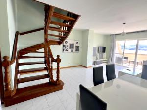 a living room with a spiral staircase and a table at Park Raxo in Raxó