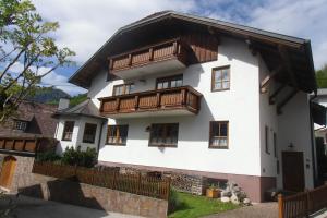 a white house with wooden balconies on it at Seepanoramablick in Gmunden