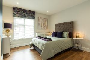 a bedroom with a large bed and a window at Ellistown Retreat in Hugglescote