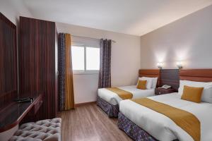 En eller flere senge i et værelse på Golden Carven Hotel