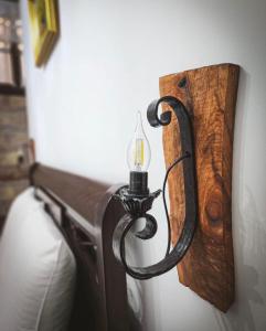 a light attached to a wall with a wooden board at White House Berat in Berat