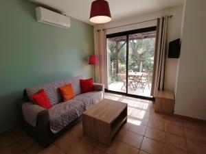 a living room with a couch and a coffee table at MAISON ALBA ROSSA 55 in Serra-di-Ferro