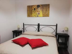 a bedroom with a bed with a red pillow on it at Sacripante in Ostellato