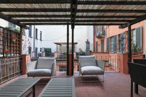 a patio with two chairs and a table on a balcony at Elegant Terrace Suite in Milan