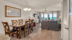 a dining room and living room with a table and chairs at Blue Nine 3 in Panama City Beach