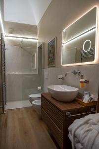 a bathroom with a sink and a toilet and a shower at Appartamento Natinguerra in Civitanova Marche