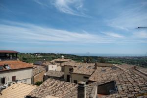 a view of roofs of a town with an airplane at Appartamento Natinguerra in Civitanova Marche