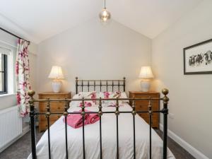a bedroom with a bed and two night stands at The Cow Shed in Stroud