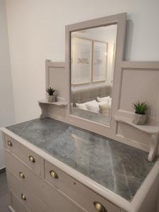 a dresser with a mirror on top of it at Casetta Pulis (Close to Airport & Valletta) in Tarxien