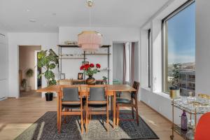 a dining room with a wooden table and chairs at Luxury apartment in the center of Tromsø in Tromsø