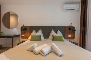 a bedroom with a large bed with green pillows at Lux Ella Apartment in Makarska