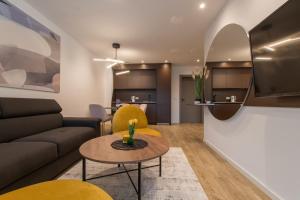 a living room with a couch and a table at Lux Ella Apartment in Makarska