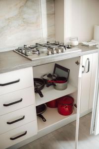 a kitchen with a stove and some pots and pans at Adrian Home Delice in Ploieşti