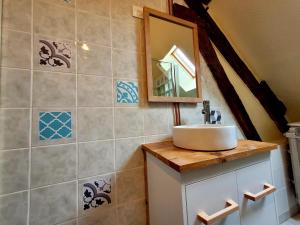 a bathroom with a sink and a mirror at Au 1894 Loft in Avize +16 photos
