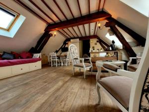 a attic living room with a couch and a table at Au 1894 Loft in Avize