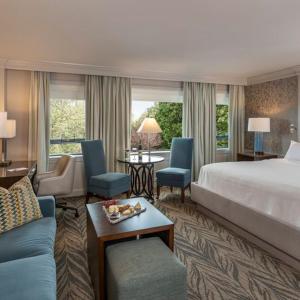 a hotel room with a bed and a table and chairs at Beechwood Hotel in Worcester