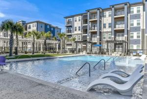 a swimming pool in front of some apartment buildings at Luxurious 1 Bedroom Apartment Near Braves Stadium in Atlanta