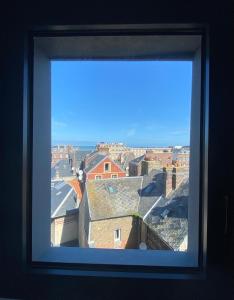 a view of a city from a window at LA TOUR AUX CRABES près de la plage in Dieppe