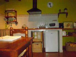 a kitchen with a white refrigerator and a microwave at El Alamo. Azagalla Rural in Casas del Abad +8 photos