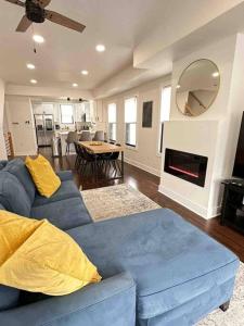a living room with a blue couch and a fireplace at Secret Escape - 20 min from NYC N 2 in Jersey City