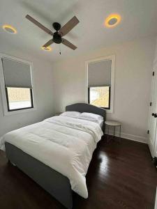 a bedroom with a bed with a ceiling fan at Secret Escape - 20 min from NYC N 2 in Jersey City
