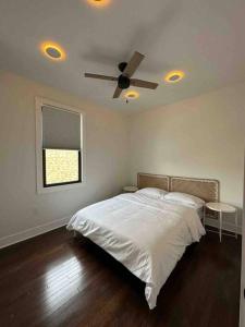 a bedroom with a bed with a ceiling fan at Secret Escape - 20 min from NYC N 2 in Jersey City