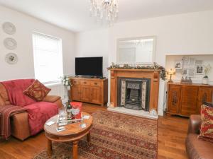 a living room with a couch and a fireplace at 2 Hartburn Road in North Shields