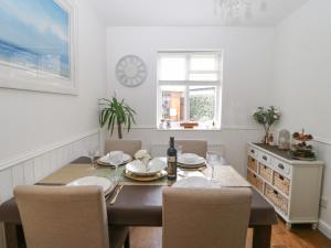 a dining room with a table and chairs at 2 Hartburn Road in North Shields