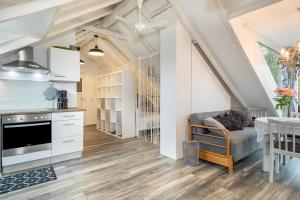 a kitchen and living room with white cabinets and a table at Straub in Meckenbeuren +14 photos