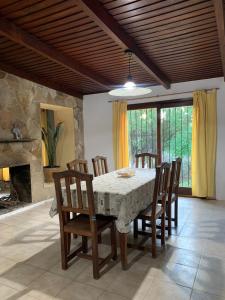 a dining room with a table and chairs and a fireplace at Casa en Barrio el Golf in Alta Gracia