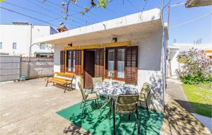 a table and chairs in front of a house at Holiday Home Premantura 02 in Premantura
