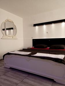 a large bed in a room with a mirror at Kice Apartments in Ohrid