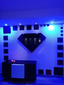 a blue room with a black wall with a tv at Kice Apartments in Ohrid