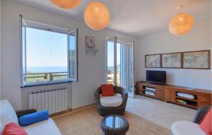 a living room with two chairs and a television at 3 Bedroom Beautiful Home In Moneglia in Moneglia