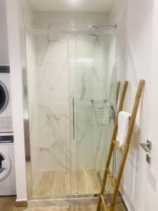 a shower with a glass door in a bathroom at Ipsos seafront in Ipsos