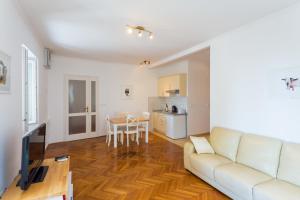 a living room filled with furniture and a table at Old City Apartments in Dubrovnik