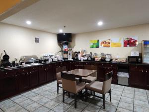 a kitchen with a table and chairs in a room at Quality Inn in Wheelersburg