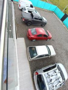 a group of cars parked in a parking lot at Quinta La Bonita Restrepo Meta 