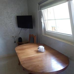 a wooden table with a cup on top of it at Saltzbork in Staraya Solʼ