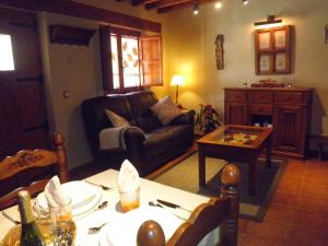 sala de estar con sofá y mesa en El Roble. Azagalla Rural, en Casas del Abad